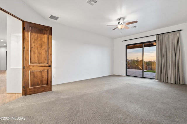 unfurnished room with visible vents, carpet flooring, and ceiling fan