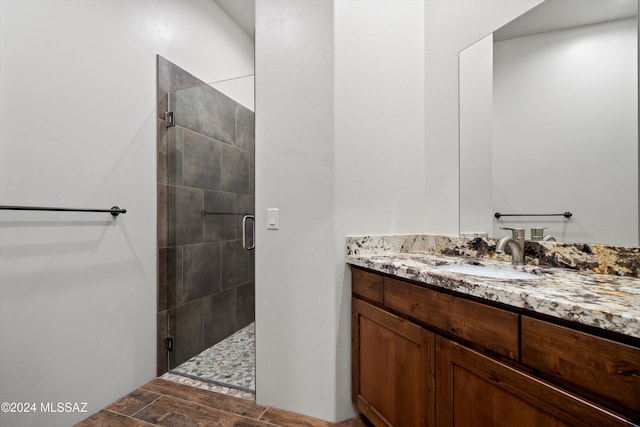 bathroom with a stall shower and vanity