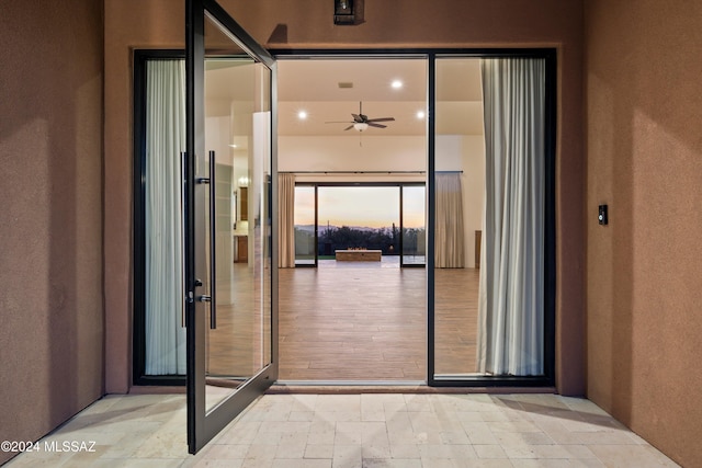 exterior entry at dusk with stucco siding