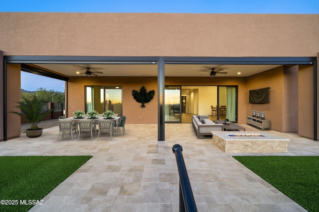 view of patio / terrace featuring outdoor dining area, a fire pit, and ceiling fan