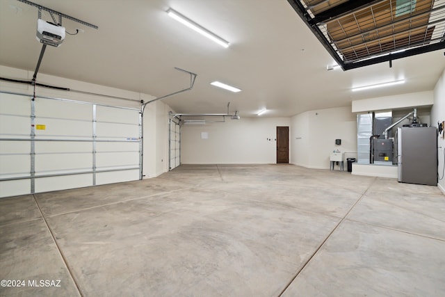 garage featuring a garage door opener and freestanding refrigerator