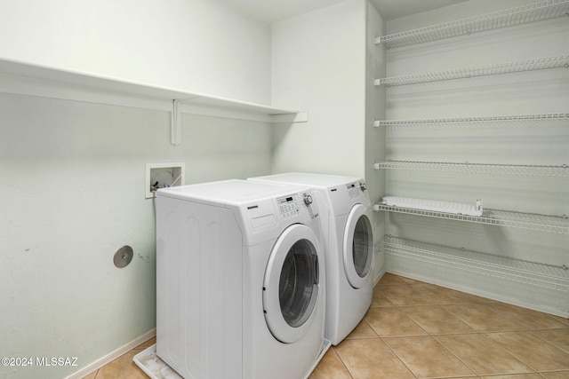 washroom featuring light tile patterned floors and washing machine and clothes dryer