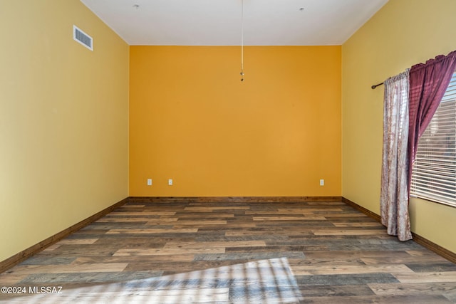 empty room with dark hardwood / wood-style floors