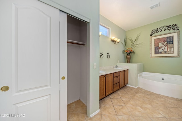 bathroom featuring vanity, tile patterned floors, and a bathtub