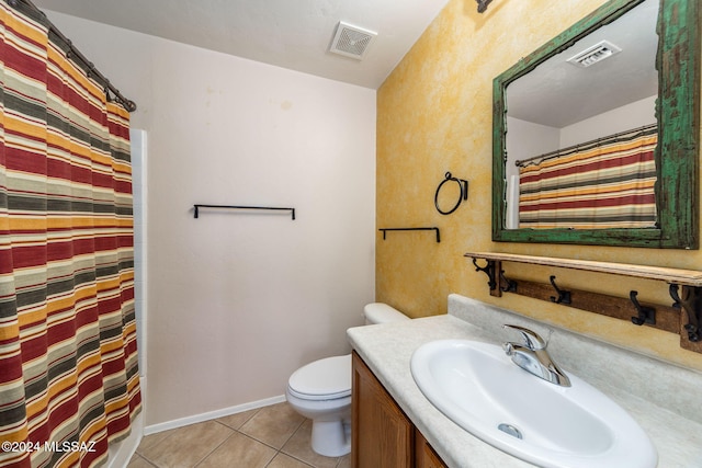 bathroom with tile patterned floors, vanity, curtained shower, and toilet