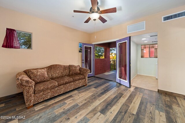 interior space with ceiling fan and dark wood-type flooring