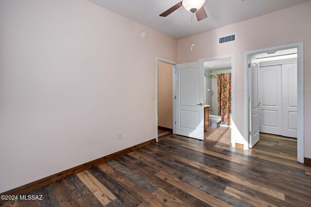 unfurnished bedroom with dark hardwood / wood-style flooring, ensuite bathroom, and ceiling fan