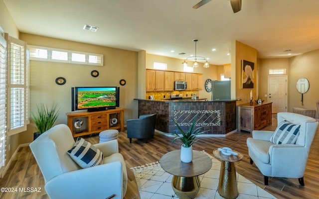 living room featuring ceiling fan and light wood-type flooring