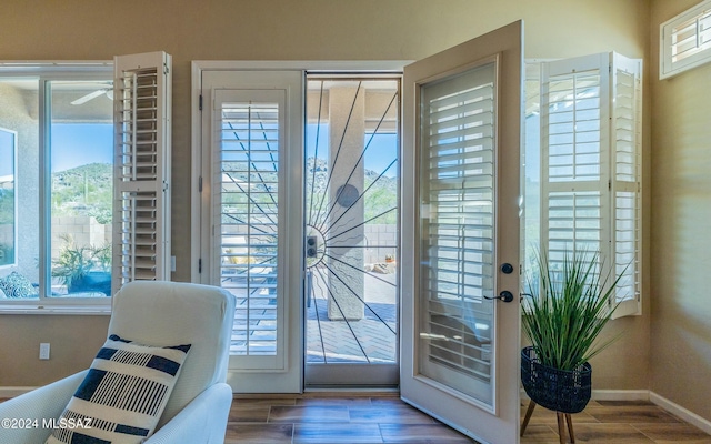 doorway to outside with a wealth of natural light and hardwood / wood-style flooring