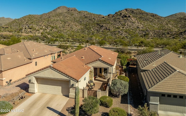 birds eye view of property featuring a mountain view