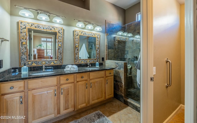 bathroom with tile patterned flooring, vanity, and tiled shower