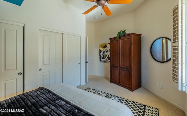 carpeted bedroom with a closet, ceiling fan, and lofted ceiling