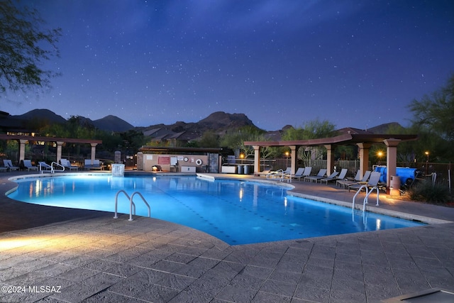 view of swimming pool featuring a mountain view and a patio area