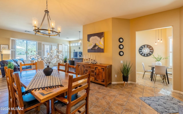 tiled dining space featuring a chandelier