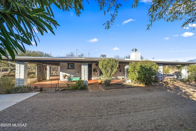 ranch-style house featuring a carport