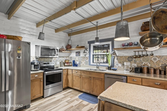 kitchen featuring sink, light hardwood / wood-style flooring, beamed ceiling, decorative light fixtures, and stainless steel appliances