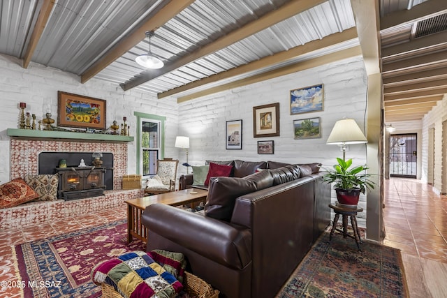living room featuring beam ceiling and a wood stove