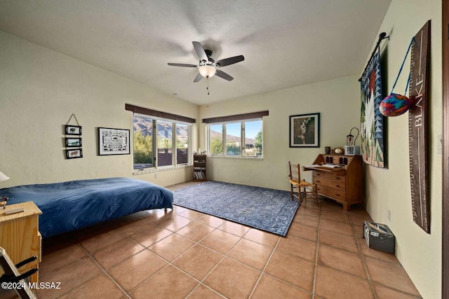 tiled bedroom featuring ceiling fan