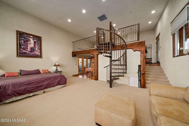 bedroom with carpet floors, a chandelier, and a high ceiling