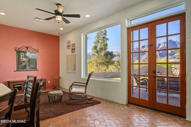 doorway to outside featuring a mountain view, french doors, and ceiling fan