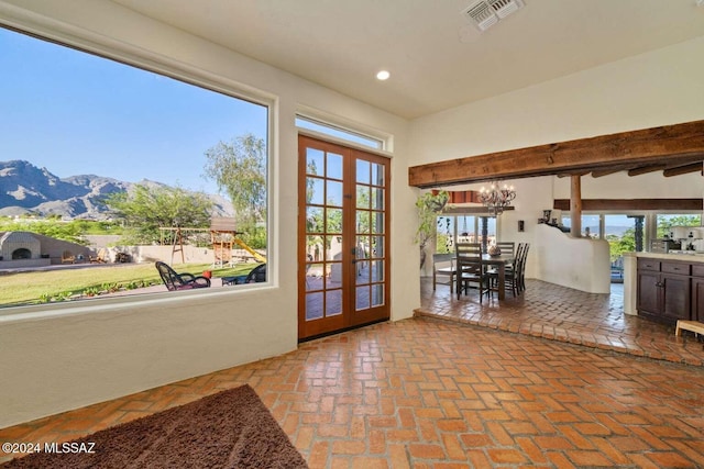 entryway featuring a mountain view, french doors, and a wealth of natural light