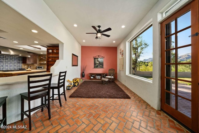 interior space with a mountain view and ceiling fan