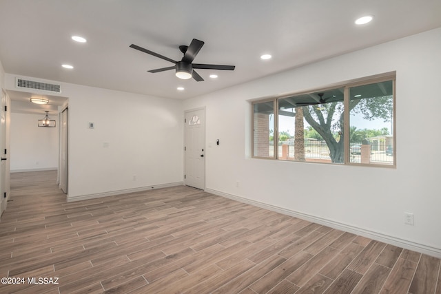 unfurnished room featuring hardwood / wood-style flooring and ceiling fan