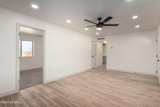 unfurnished room with ceiling fan and light wood-type flooring