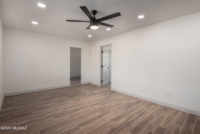 spare room featuring ceiling fan and dark hardwood / wood-style floors