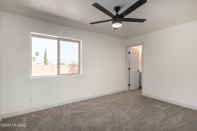 spare room featuring carpet flooring and ceiling fan