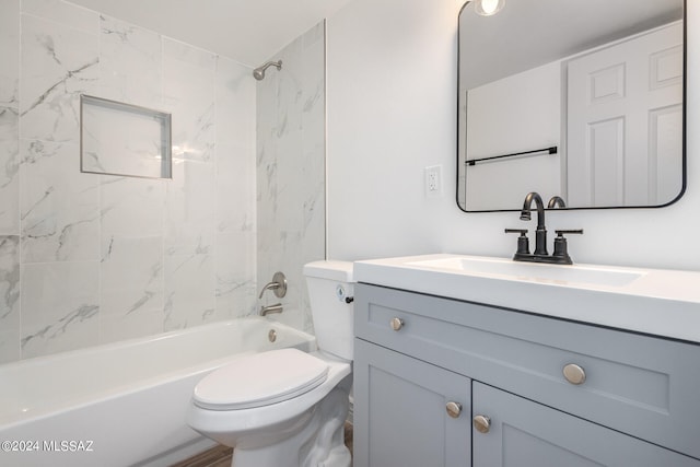 full bathroom with vanity, toilet, and tiled shower / bath