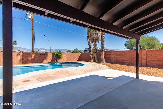 view of patio with a fenced in pool