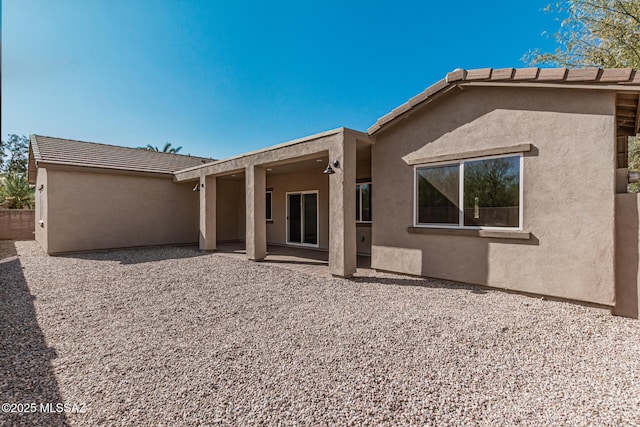 back of property with a patio