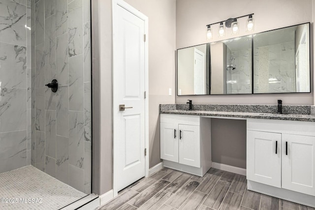 bathroom featuring vanity and tiled shower