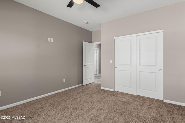 unfurnished bedroom with carpet floors, ceiling fan, and a closet