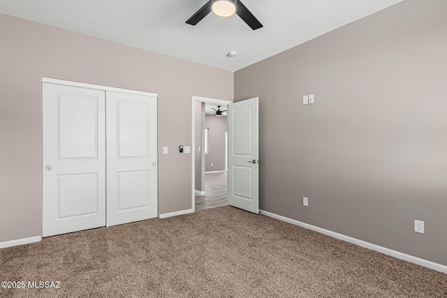 unfurnished bedroom with carpet floors, a closet, and ceiling fan