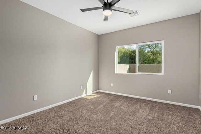 empty room featuring ceiling fan and carpet