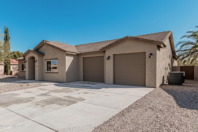 view of front of home with a garage and cooling unit