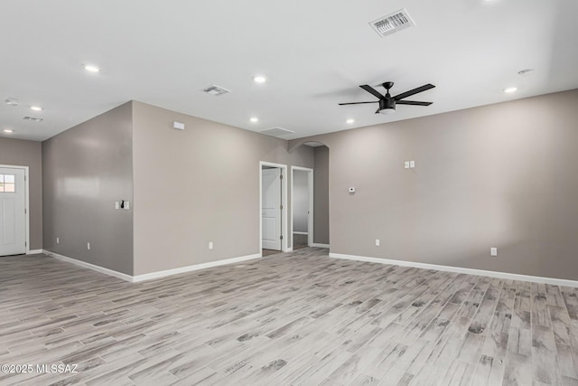 empty room with ceiling fan and light wood-type flooring