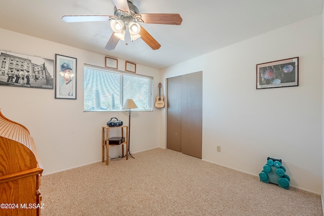 interior space with ceiling fan