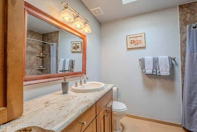 bathroom featuring vanity, toilet, and walk in shower