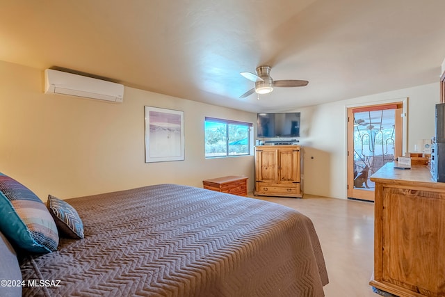 bedroom featuring a wall unit AC, ceiling fan, concrete flooring, and access to outside