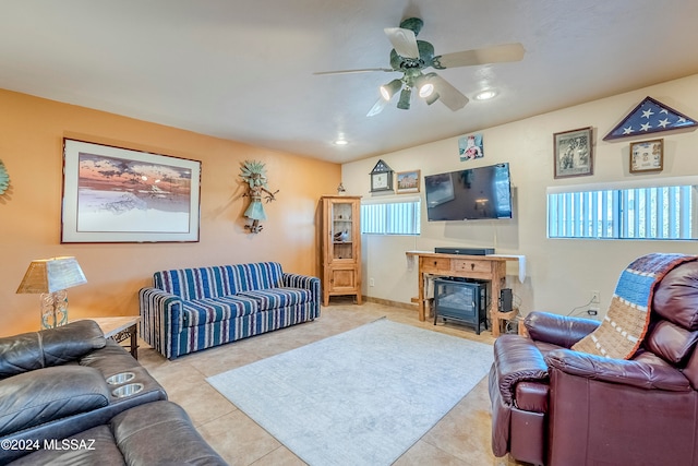 living room featuring a fireplace, light tile patterned floors, and ceiling fan