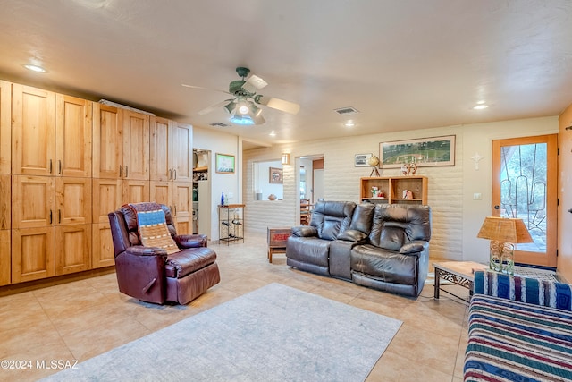 living room with ceiling fan and light tile patterned flooring