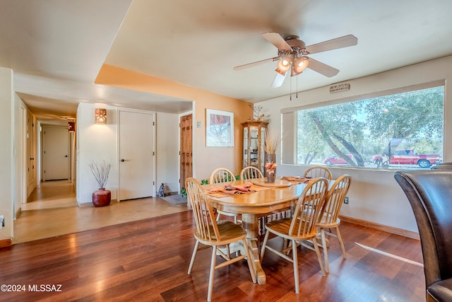 dining space with hardwood / wood-style flooring and ceiling fan