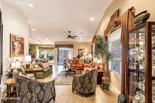 living room with a wealth of natural light, ceiling fan, and light tile patterned floors