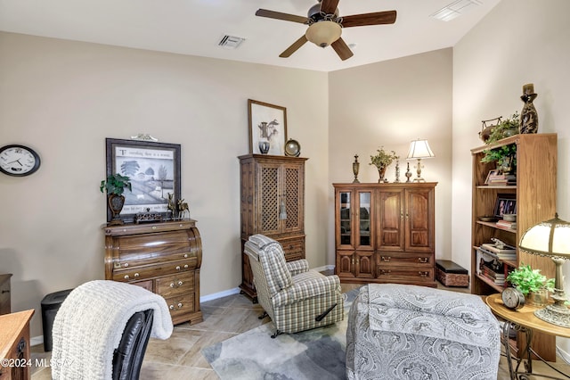 sitting room with ceiling fan and vaulted ceiling