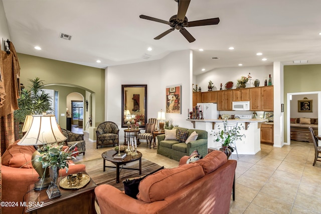 tiled living room with ceiling fan and lofted ceiling