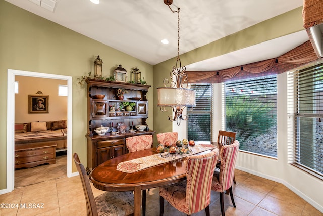 tiled dining space featuring vaulted ceiling