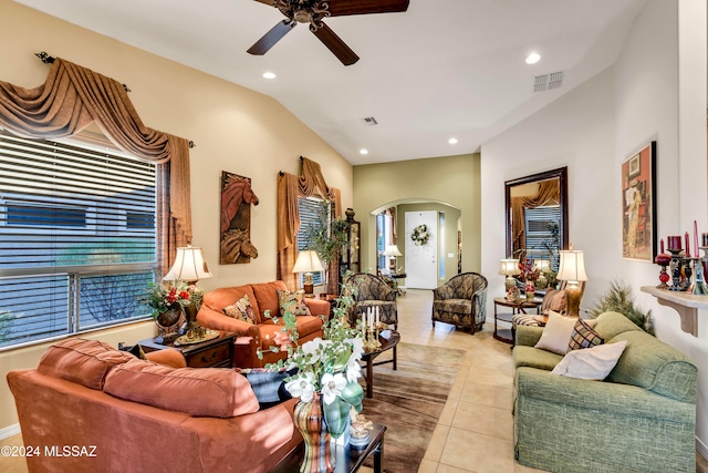 tiled living room featuring ceiling fan and vaulted ceiling